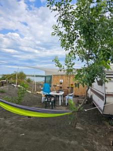 a hammock in a yard next to an rv at Beachfront Caravans in Chernomorets +82 photos