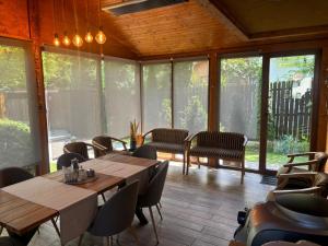 a dining room with tables and chairs and windows at Chalet Milenium Residence Bran in Bran