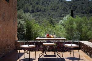 a table and chairs on a patio with a view at Fangar Agroturismo in Campanet +174 photos