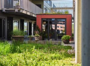a building with potted plants on the side of it at Hotel GUESTapart in Aarhus