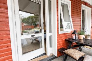 a sliding glass door on a house with a table at Danhostel Stevns Klint in Store Heddinge