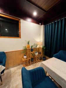 a room with two beds and a blackboard at Hotel Mid Orchard Kasol -River Side in Kasol