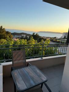 a wooden table and a chair on a balcony at Apartment Aurea in Makarska