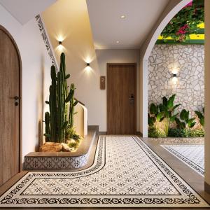 a hallway with a cactus in front of a door at Plum Village Moc Chau in Mộc Châu