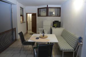 a room with a table and chairs and a couch at Apartments Villa Ypsilon in Sveta Nedelja