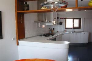 a kitchen with white cabinets and a stove top oven at Casa de la Media Luna in El Pozo del Cabo +49 photos