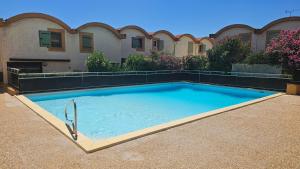 a large swimming pool in front of a building at Studio avec accès direct sur le port de Gruissan in Gruissan