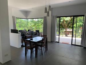 a living room with a table and chairs and a couch at Designer Villa "Sunset Hills" with Pool in Puerto Princesa City