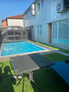 a swimming pool in a yard next to a building at Royal Apartments & Rooms in Zagreb