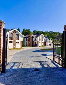 a gate to a driveway in a residential neighborhood at Royal Villa - HAWAII in Vrnjačka Banja