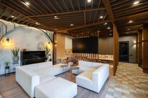 a living room with white couches and a screen at RIS Signature Villa Zovuni in Yerevan