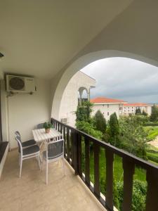 a balcony with a table and chairs and a view at Cozy apartment in Kambani 1 in Sveti Vlas