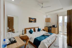 a bedroom with a bed and a table in it at The Lodgers Studio Apartment Near Mall FiftyOne Gurugram in Gurgaon +32 photos