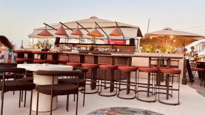 a bar with chairs and tables and umbrellas at LimonoSpito in Koroni