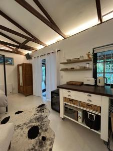 a large kitchen with a counter and a table at Urban Plett in Plettenberg Bay