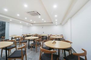 an empty restaurant with tables and chairs at OYO Townhouse 588 Noida Sector 71 Near ISKCON Temple Noida in Indirapuram