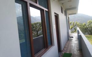 a hallway of a building with windows and a view at Sanjay Holiday Home by StayApart in Barkot