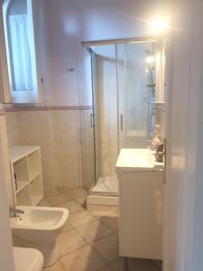 a bathroom with a shower and a toilet and a sink at La casa delle Camelie in Meta +14 photos