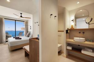 a hotel room with a bed and a bathroom with a view at Inmood Aucanada 4 Sup in Port d'Alcudia