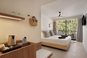 a bedroom with a bed and a living room with a table at Inmood Aucanada 4 Sup in Port d'Alcudia