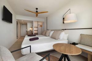 a bedroom with a large white bed and a table at Inmood Aucanada 4 Sup in Port d'Alcudia