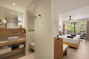 a hotel room with a bed and a bathroom at Inmood Aucanada 4 Sup in Port d'Alcudia