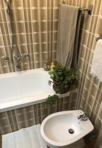 a bathroom with a toilet and a sink and a shower at Fior di Loto in Ravenna +7 photos