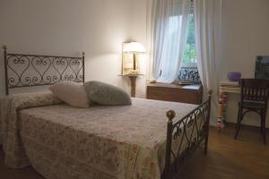 a bedroom with a bed and a table and a window at Fior di Loto in Ravenna