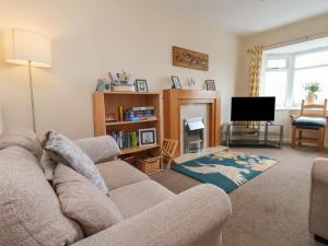 a living room with a couch and a television at North Terrace in Saltburn-by-the-Sea