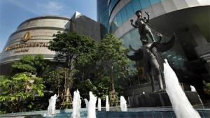 a fountain in front of a building with a statue at InterContinental Bangkok by IHG in Bangkok