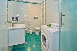 a bathroom with a washing machine and a sink at Beautiful SeaView Villa in Hvar