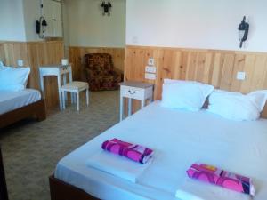 Postel nebo postele na pokoji v ubytování Rony Hotel