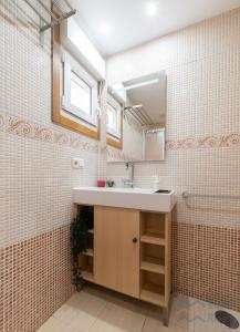 a bathroom with a sink and a mirror at Fogar do Freixo - by entreRías in Cangas de Morrazo