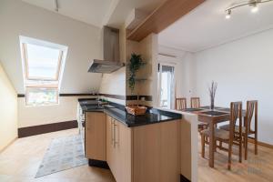 a kitchen with a counter top and a dining room at Fogar do Freixo - by entreRías in Cangas de Morrazo +11 photos
