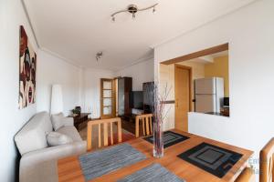 a living room with a couch and a table at Fogar do Freixo - by entreRías in Cangas de Morrazo