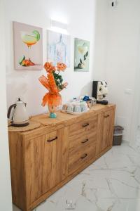 a wooden cabinet with a vase on top of it at La Loggia Suite in Marsala