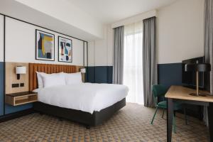 a hotel room with a bed and a desk at voco Belfast by IHG in Belfast