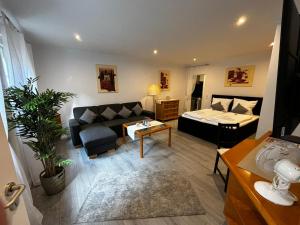 a living room with a couch and a bed at Residenz Royal in Sandhausen
