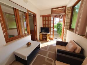 a living room with a couch and a table at RIKY Ap4 - few steps from the beach in Novigrad Istria