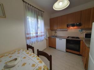 a kitchen with a table and a table and a dining room at RIKY Ap4 - few steps from the beach in Novigrad Istria