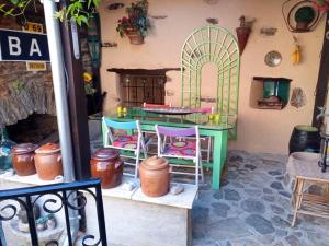 a room with a table and chairs in a house at Maison de village chez Cathy in Bor-et-Bar +5 photos