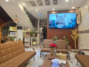 a cat sitting on a screen in a store at Dar Al Salaam Hospitality House in Nizwa
