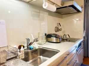 a kitchen with a sink and a counter top at toya町家-chitose in Toyama +12 photos