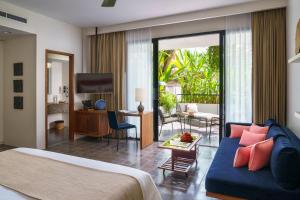 a bedroom with a bed and a living room at Viroth's Hotel in Siem Reap
