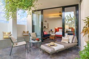 a living room with a couch and a bedroom at Viroth's Hotel in Siem Reap