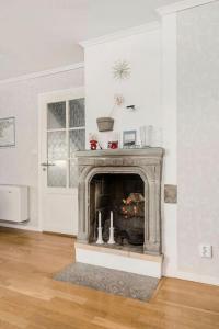 una sala de estar con chimenea en una habitación blanca en Large 4 bedroom Villa with beautiful garden, en Visby