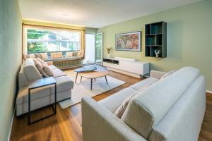 a living room with two couches and a table at Haus Cervino - luxury apartment in Zermatt