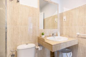 a bathroom with a toilet and a sink and a mirror at La Terracita de Candi El Puerto in El Puerto de Santa María +19 photos