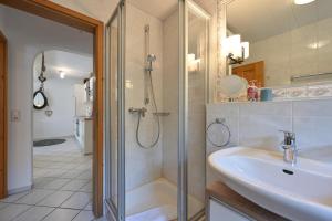 a bathroom with a sink and a shower at Ferienwohnung Alpina in Roßhaupten +18 photos