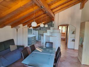 a living room with a couch and a table at Mansarda Belvedere in Molveno